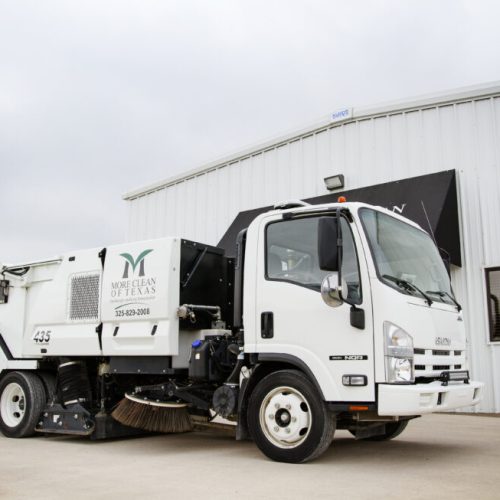 More Clean of Texas sweeper truck in front of More Clean of Texas offices